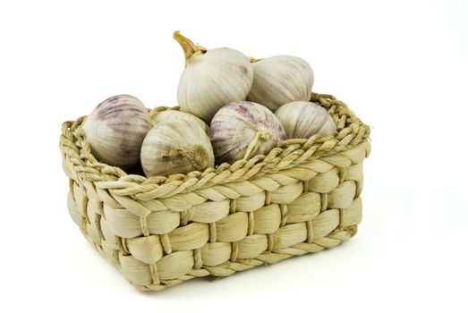 Basket full of fresh garlics isolated on white background