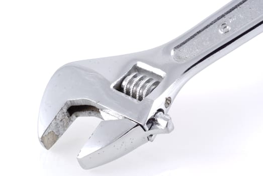 Close up of a monkey wrench on a white background.