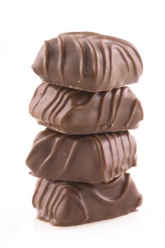 Four belgian bonbons on top of eachother, isolated on white.