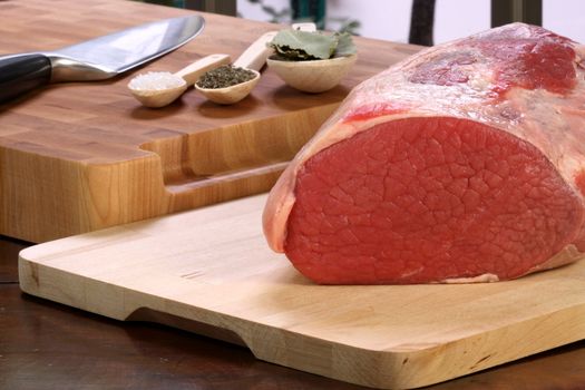 raw fresh and juicy eye of round roast steak or beef  with ingredients on background  perfect for baking and roasting