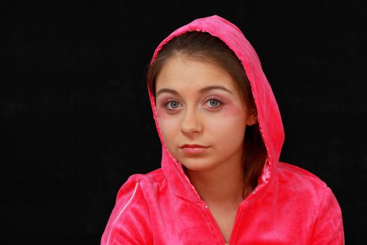 Zoung girl in pink portrait isolated on black