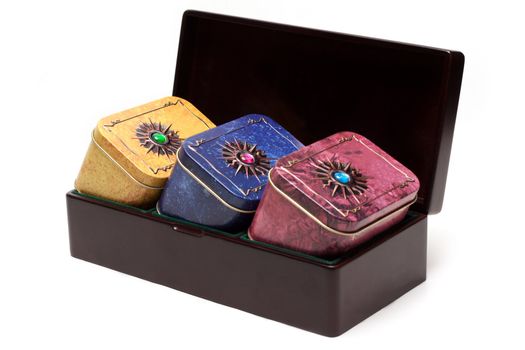 Box with tea, iron packing, decorated stone on white background