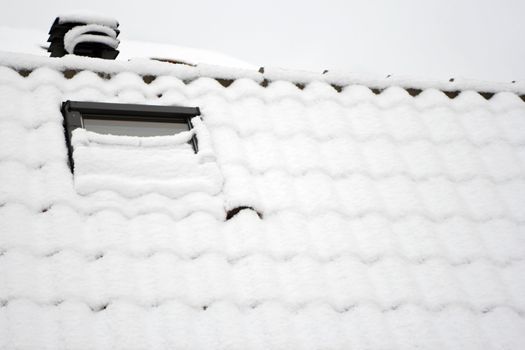 Snow over the roof, covered window