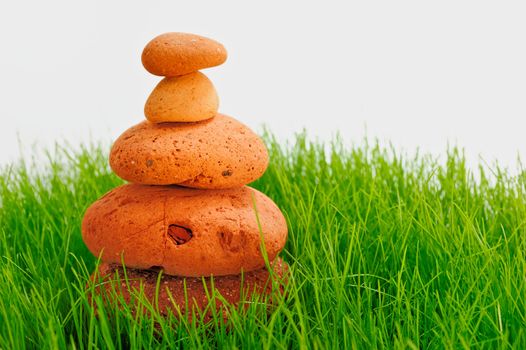 Pyramid of red cobble-stones in the green grass