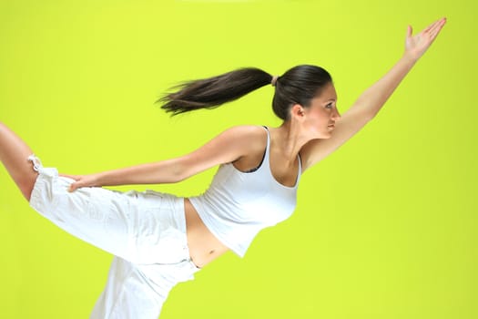 Young yoga female doing yogatic exericise on flor