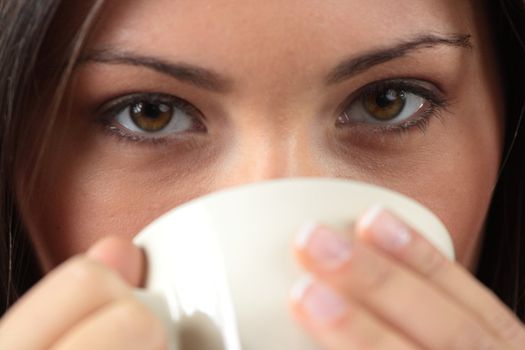 Young woman with beautiful face is having her tea/coffee