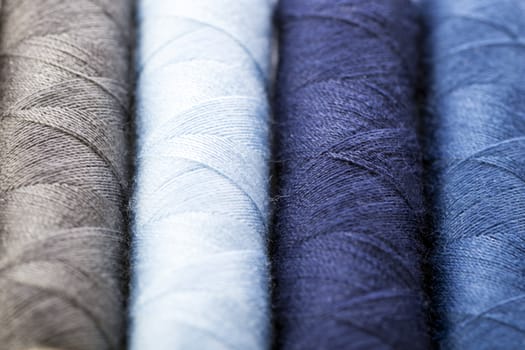 Cotton threads in shades of blue and gray.