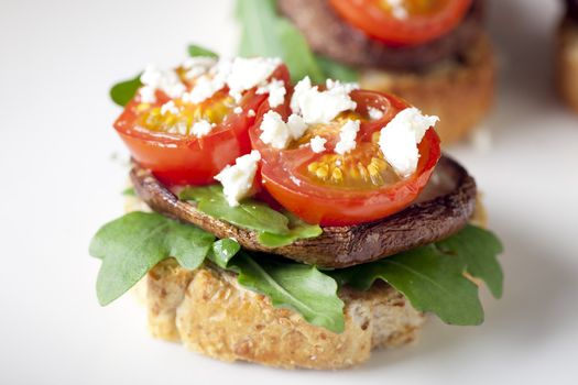 Shitake mushroom tapas with cherry tomatoes and crumbled  feta cheese.