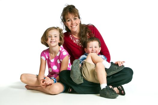 Beautiful young woman with her happy son and daughter against a white background.