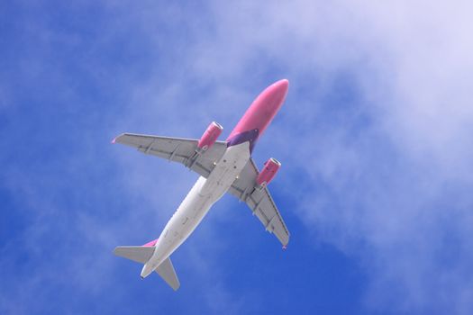 Jet airplane on almost clear blue sky witch some clouds