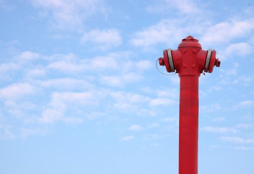 Hydrant, water-hose against blue sky