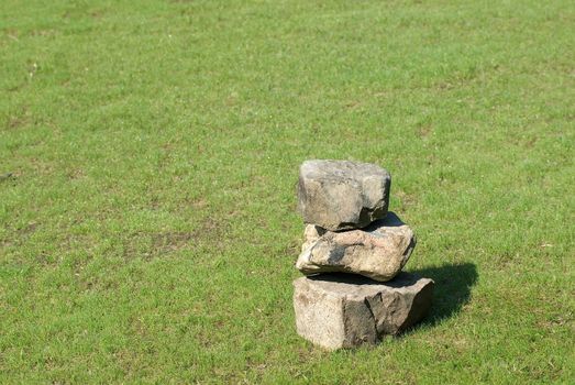 There were tree stones on a grassland.