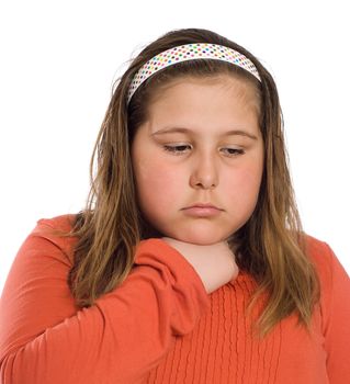 Closeup view of a young girl with a sore throat isolated against a white background