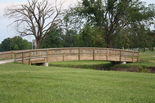 A wooden bridge over a small creek