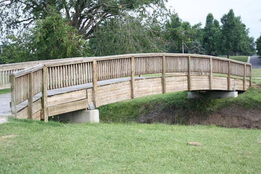 a wooden bridge over a  small creek