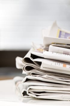 pile of newspapers on the table