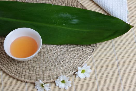 Tropical Spa background (green leaf, white flowers, oil)