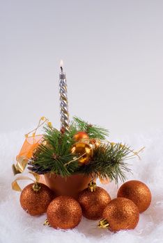 Christmas orange spheres and the silver candles on the white fur