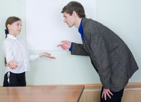 Tutor explains something to the little girl