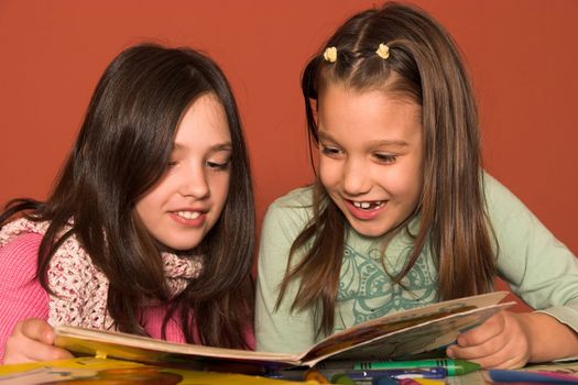 girls reading book in classroom