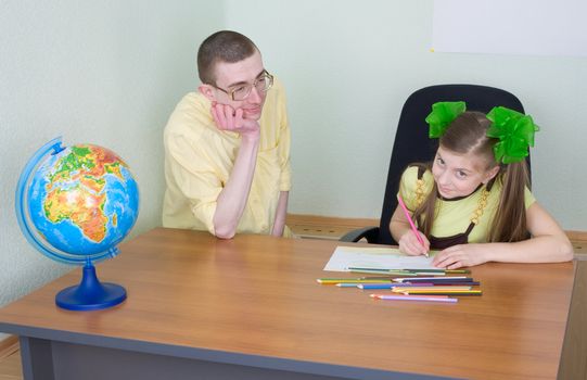 The girl and brother with color pencils