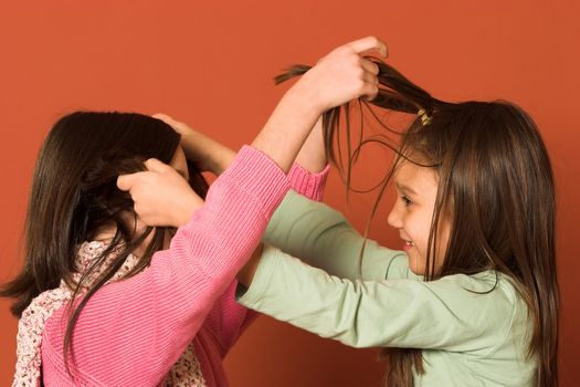 two pretty girls touching hair