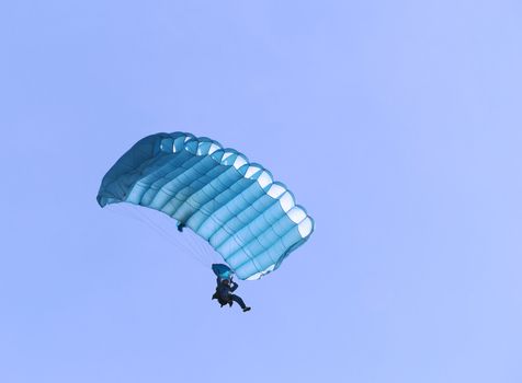 A blue parachute on a bright sunny day.