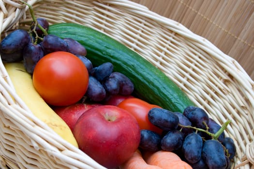 Vegetables and fruits in a basket. Close-up.