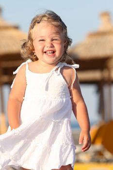 Beauty a little girl at beach in the sea 