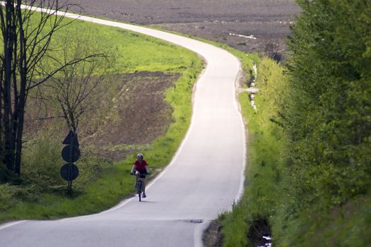 A red shirt woman climbing on bike