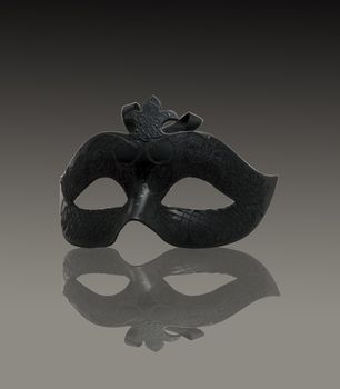 A venetian black mask on gray gradient background