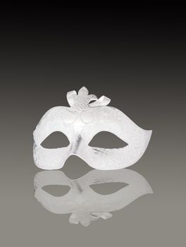 A venetian white mask on gray gradient background