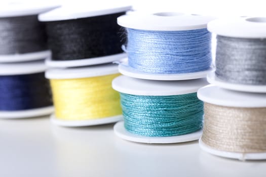 Close up of colorful spools of thread .