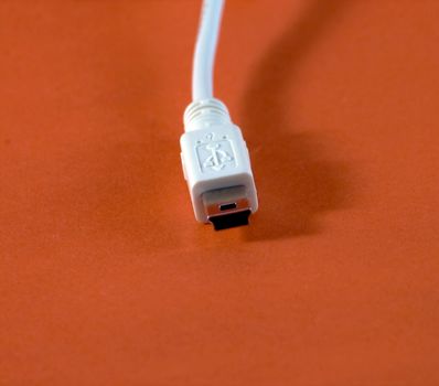 A white USB plug on red background