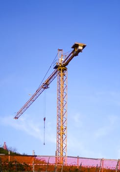 Yellow crane working on blue sky