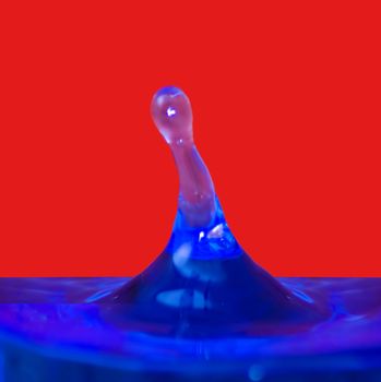Drop of water on blue and red