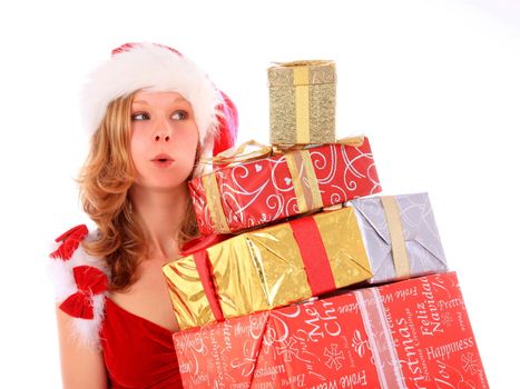 young woman in santa claus costume is carrying a pile of gift boxes - looking with puckering lips at the golden top box