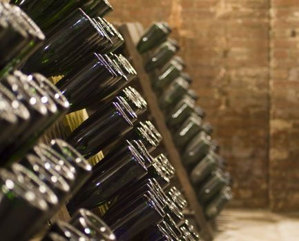 Closeup of bottles of wine aging in an old cellar