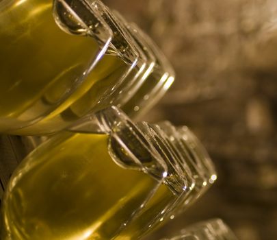 Closeup of bottles of wine aging in an old cellar