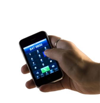 Hand of caucasian man holding a touch screen phone