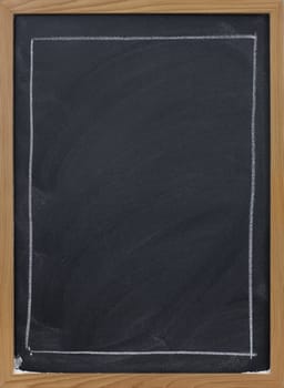 blank blackboard in wooden frame, large rectangle sketched with white chalk, eraser smudge patterns