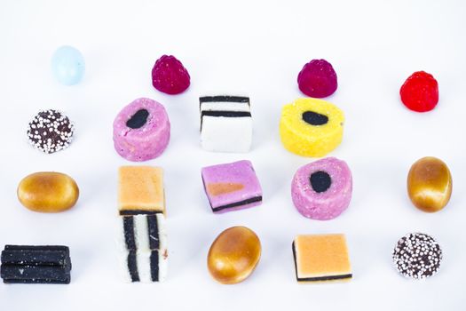 Candies in a row on white background