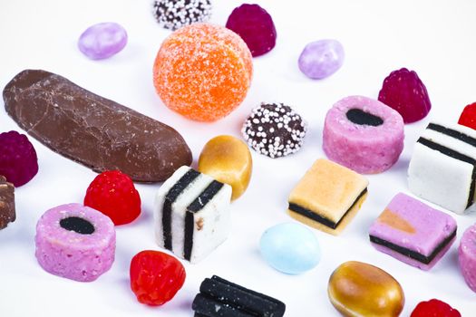 Candies in a row on white background