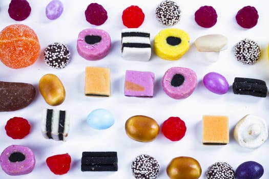 Candies in a row on white background