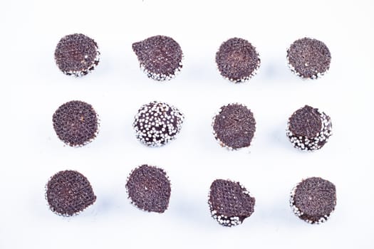 Delicious chocolate pralines over white background.