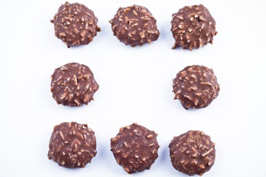 Delicious chocolate pralines over white background.