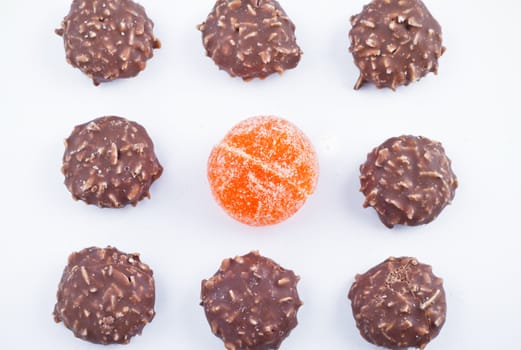 Delicious chocolate pralines over white background.