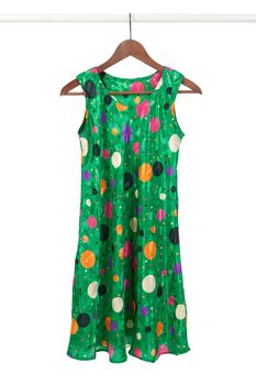 Bright green funky dress on a wooden hanger, isolated on white.