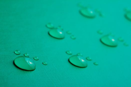 Footprints accomplished on the basis of drops of water on a green background