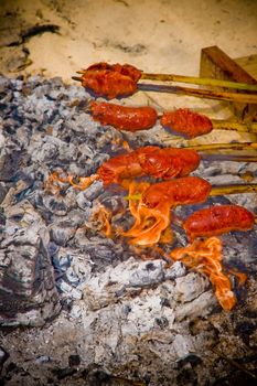 Farm sausages getting cooked on a barbecue